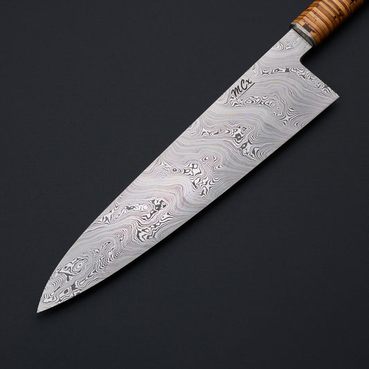 MCx Johnsson × Krichbaum 240mm Björkmans Twist gyuto, blade face and stacked birch-bark handle