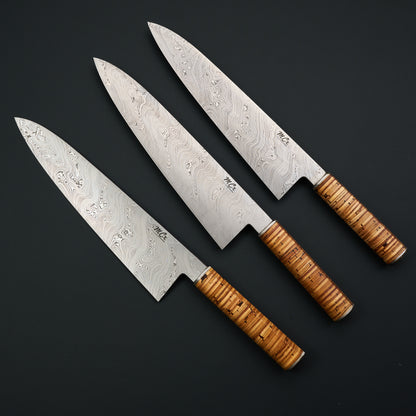 Three MCx Edition 01 gyutos with stacked birch-bark handles