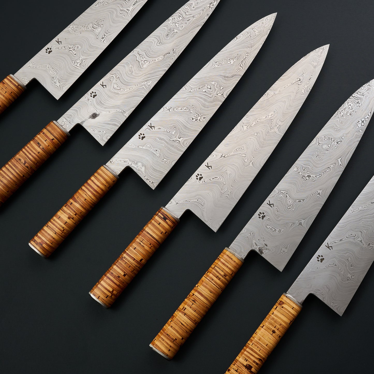 Six Johnsson × Krichbaum Edition 01 gyutos with individual Björkmans Twist patterns